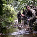 Rifleman Lance Cpl. John Jones with Combat Assault Company, 3rd Marine Regiment, 3rd Marine Division, signals to fellow Marines as he patrols with Malaysian Army Rangers in Malaysia during Cooperation Afloat Readiness and Training 2008. CARAT 2008 is a series of bilateral exercises between U.S. armed forces and six Southeast Asian countries.