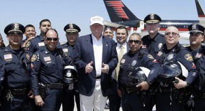 Republican presidential hopeful Donald Trump, center, poses for a photo with Laredo Police officers before Trump's departure from Laredo, Texas, Thursday, July 23, 2015. (AP Photo/LM Otero)