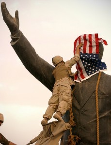 PICTURE BY PETER NICHOLLS THE TIMES-BAGHDAD 09/04/03 US SOLDIER PLACES STARS AND  STRIPES OVER STATUE OF SADDAM, PRIOR TO PULLING IT DOWN