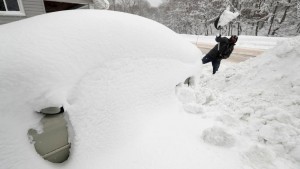 Raid H digs his car out in his driveway, Friday, Dec. 29, 2017, in Erie, Pa. The cold weather pattern was expected to continue through the holiday weekend and likely longer, according to the National Weather Service, prolonging a stretch of brutal weather blamed for several deaths, crashes and fires. (AP Photo/Tony Dejak)