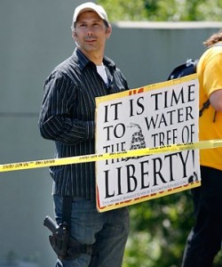 Obamacare protester with sign-8x6